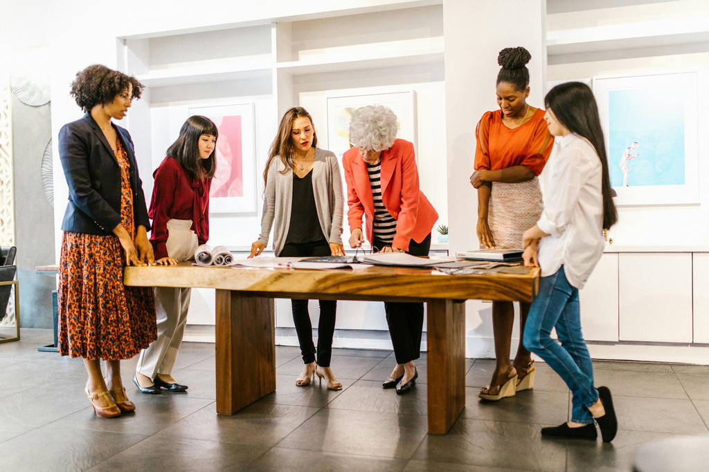 A group of professional women collaborating on a project, highlighting empathy and teamwork in emotionally intelligent leadership.