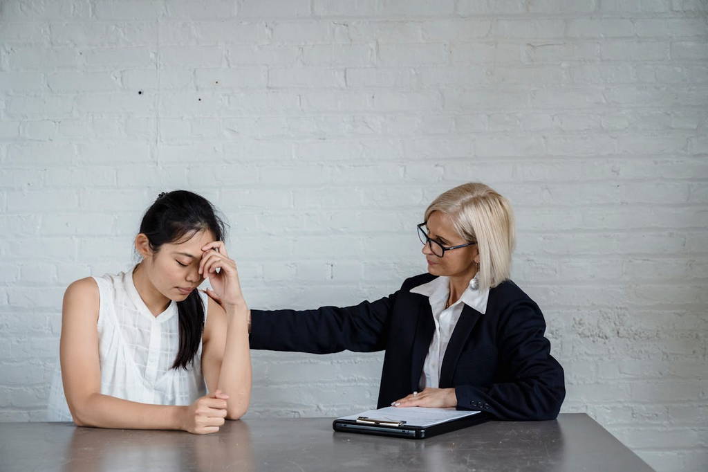 A compassionate leader supporting a stressed team member, emphasizing the importance of emotional intelligence in leadership.