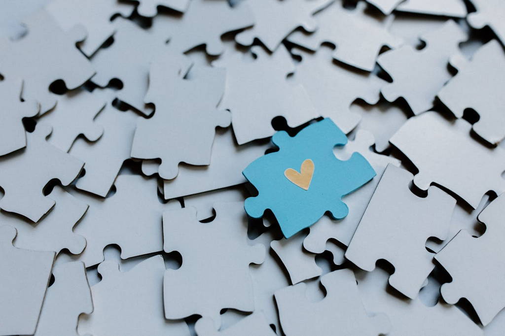 A unique puzzle piece with a heart symbolizing emotional intelligence as the missing key to strong leadership and workplace harmony.